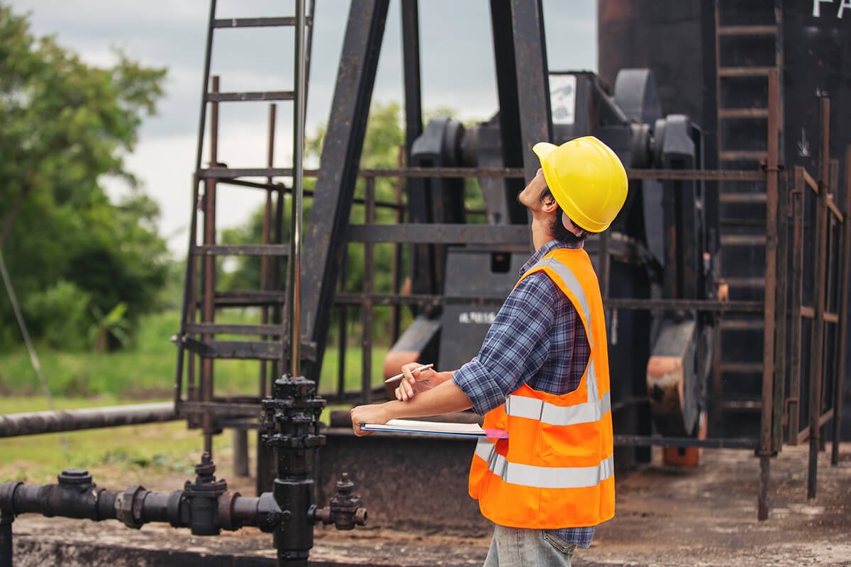workers-standing-checking-beside-working-oil-pumps (2)